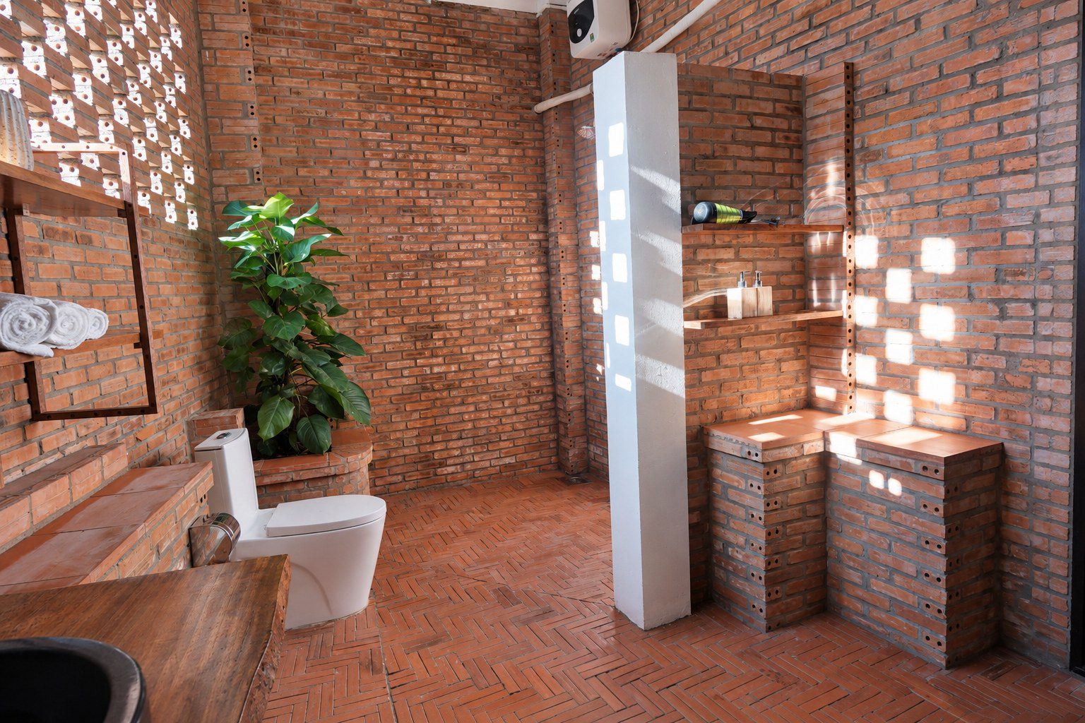 Red-brick bathroom with plants