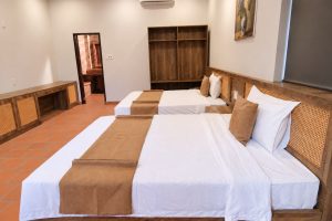Bedroom with two beds and wooden headboards